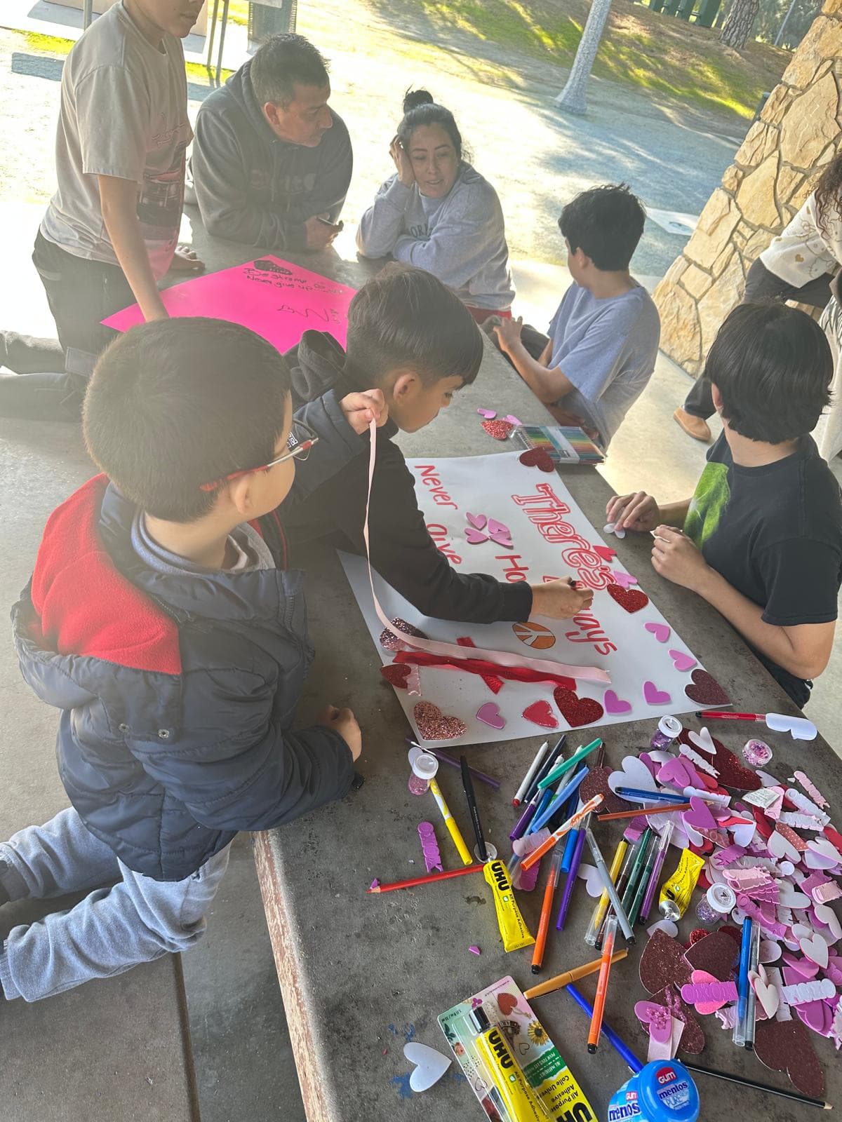 Young children painting cardboards for the Inspired Voices initiative